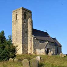 Load image into Gallery viewer, A village church with gravestones and blue sky.
